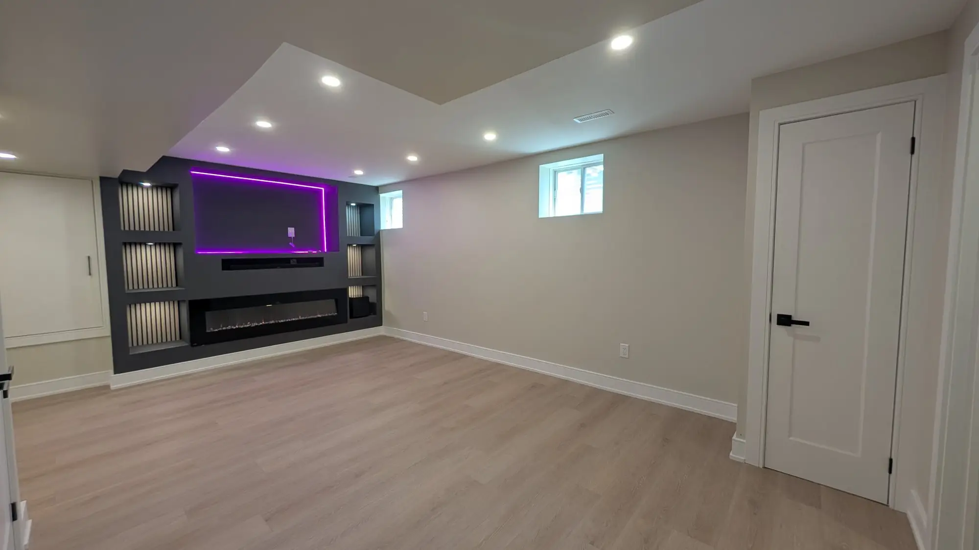 The finished lower floor with built-in media wall