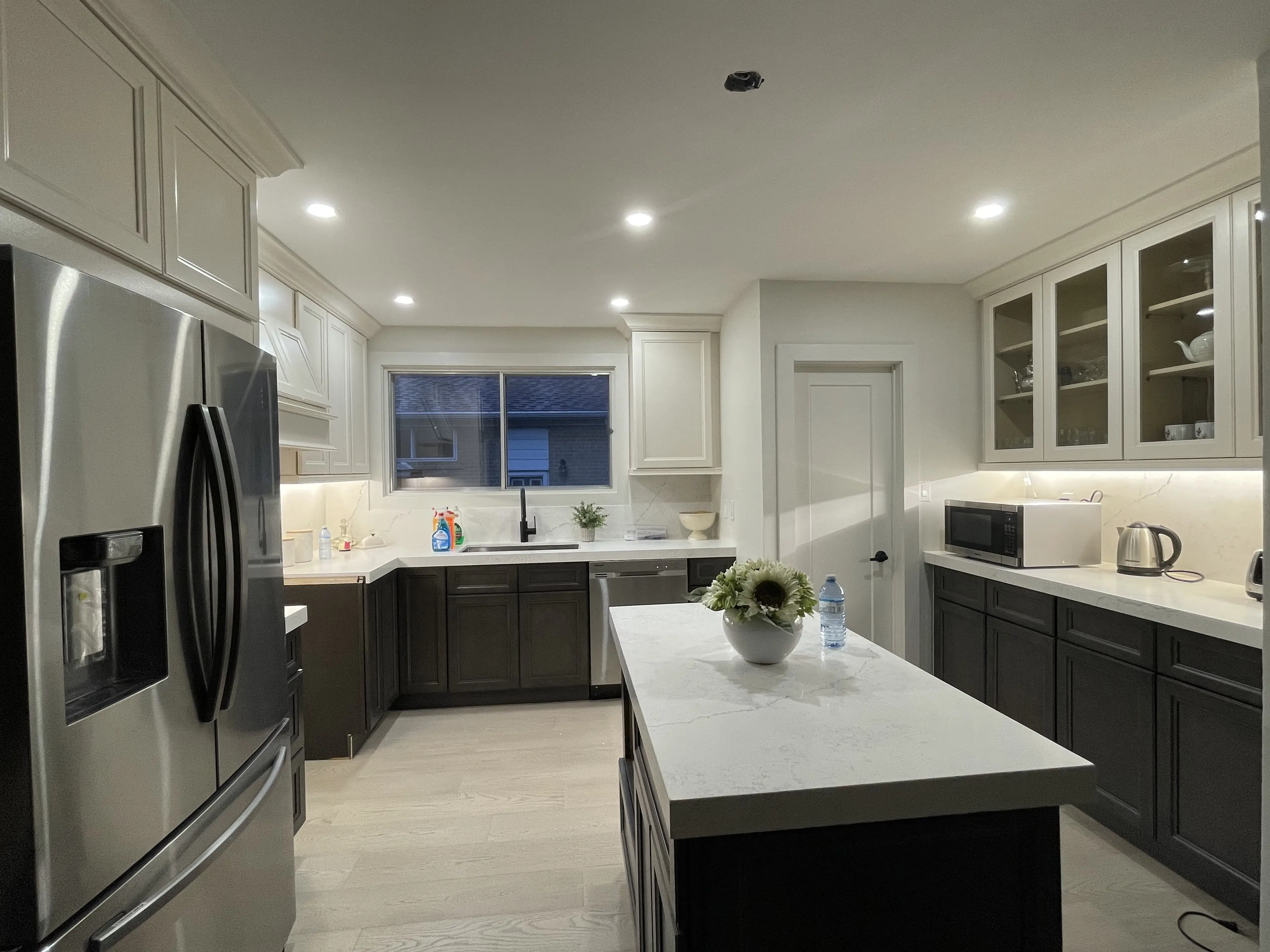 Kitchen renovation detail — custom range hood and tile backsplash