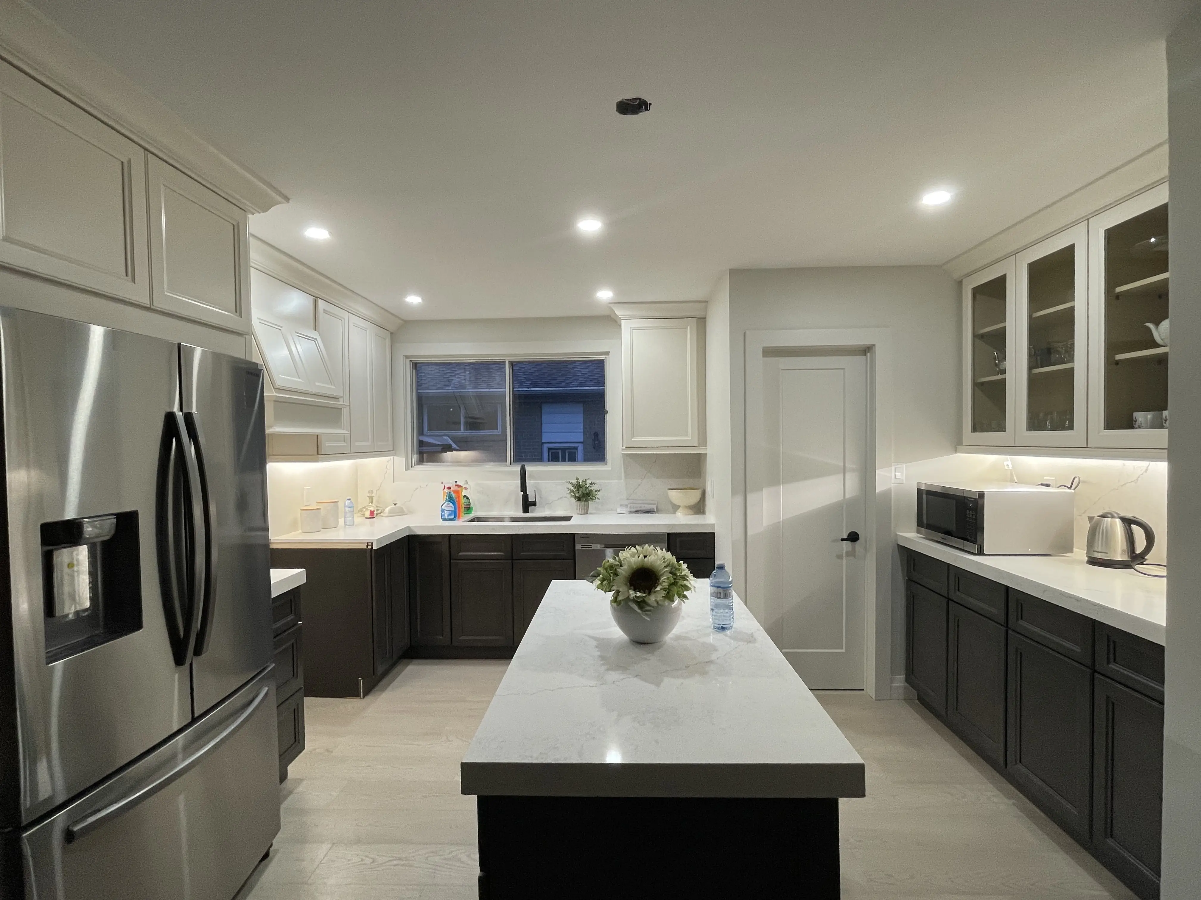 Finished kitchen renovation with island and under-cabinet lighting